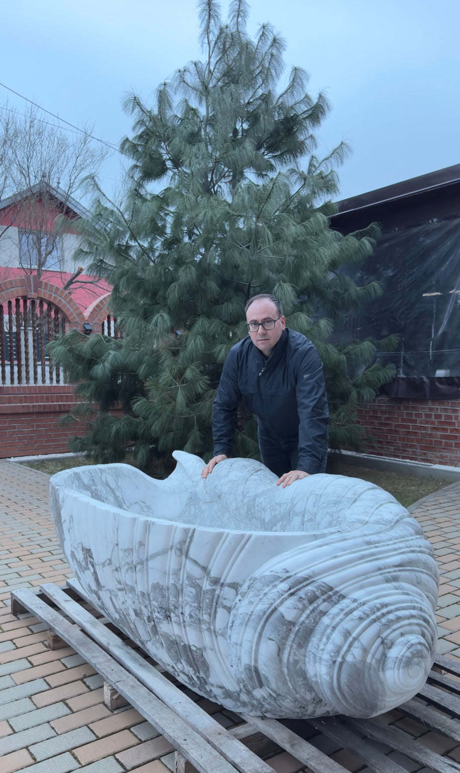 Original photo of Monumental Conch Shell Marble Bathtub with owner